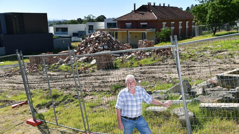 Former boss of the old
Kew insitution Max Jackson
amongst dilapidated heritage
buildings